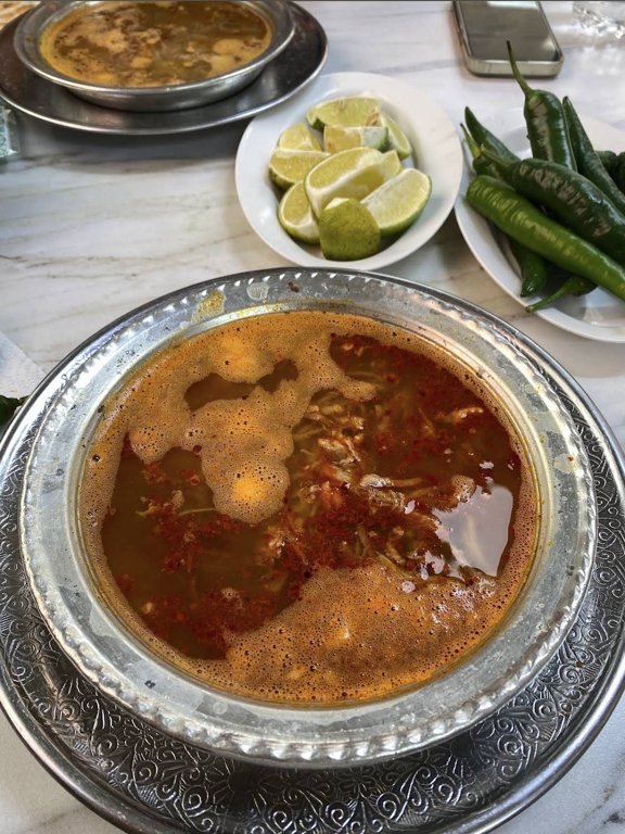 Beyran with lemon wedges and green peppers at Beyranci Ejder Usta in Gaziantep