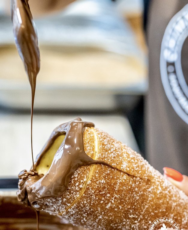 Chocolate sauce added to chimney cake at Chimney Cake Shop