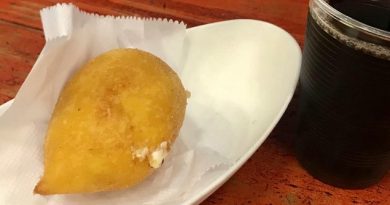 Golden teardrop-shaped coxinhas served on a white plate