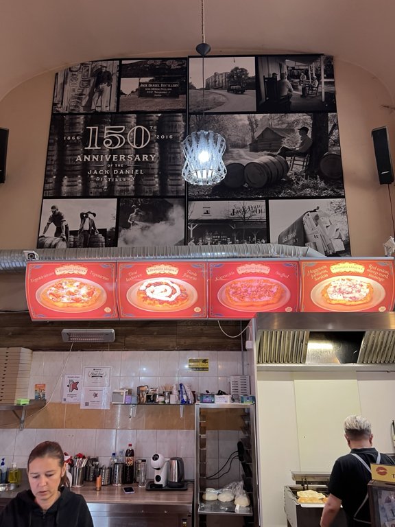 The high ceiling, menu boards and preparation counter inside Krumplis