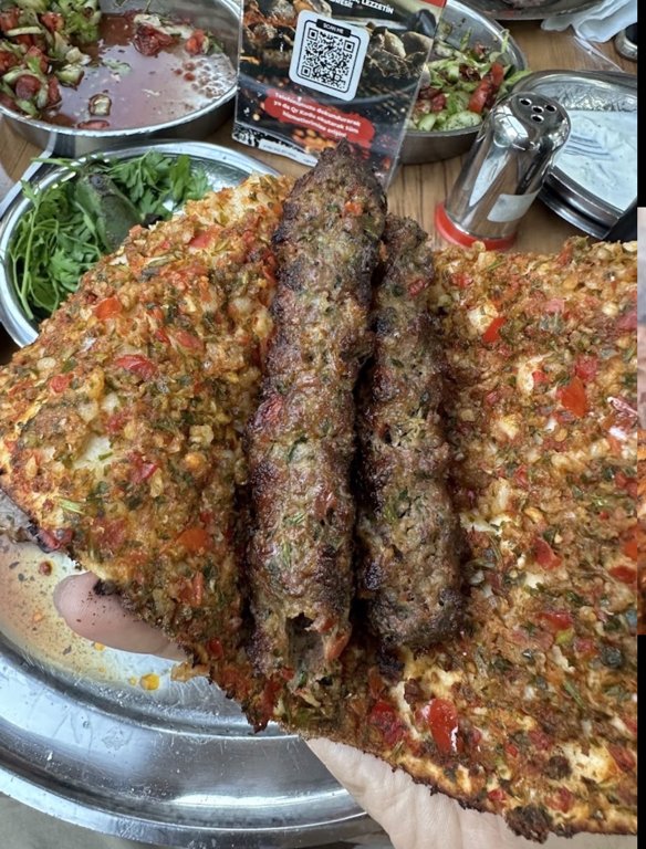 Kebab served with lahmacun and salads at Küşlemeci Mehmet Usta