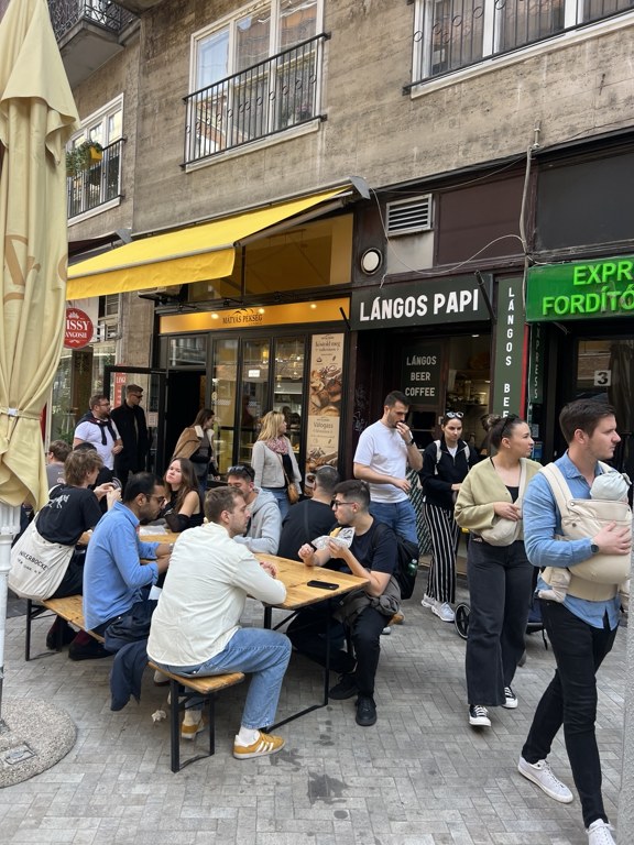 Langos Papi shop and outdoor wooden tables in Budapest