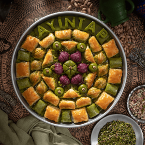 Mixed baklava and pistachio pastries on an Ayıntap Baklava tray