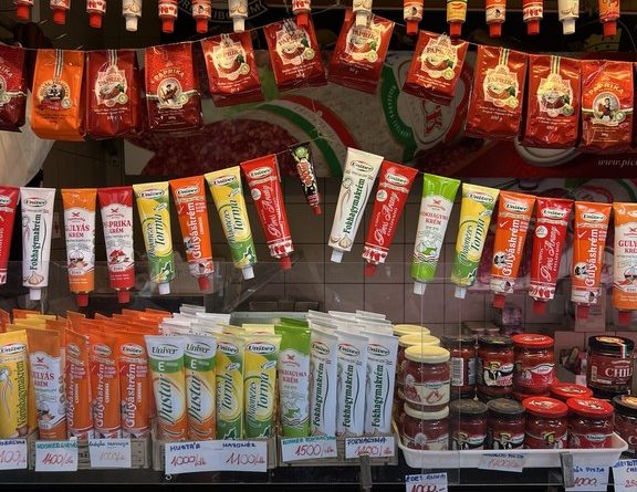 Paprika powders and pepper pastes on shelves at Budapest Central Market Hall