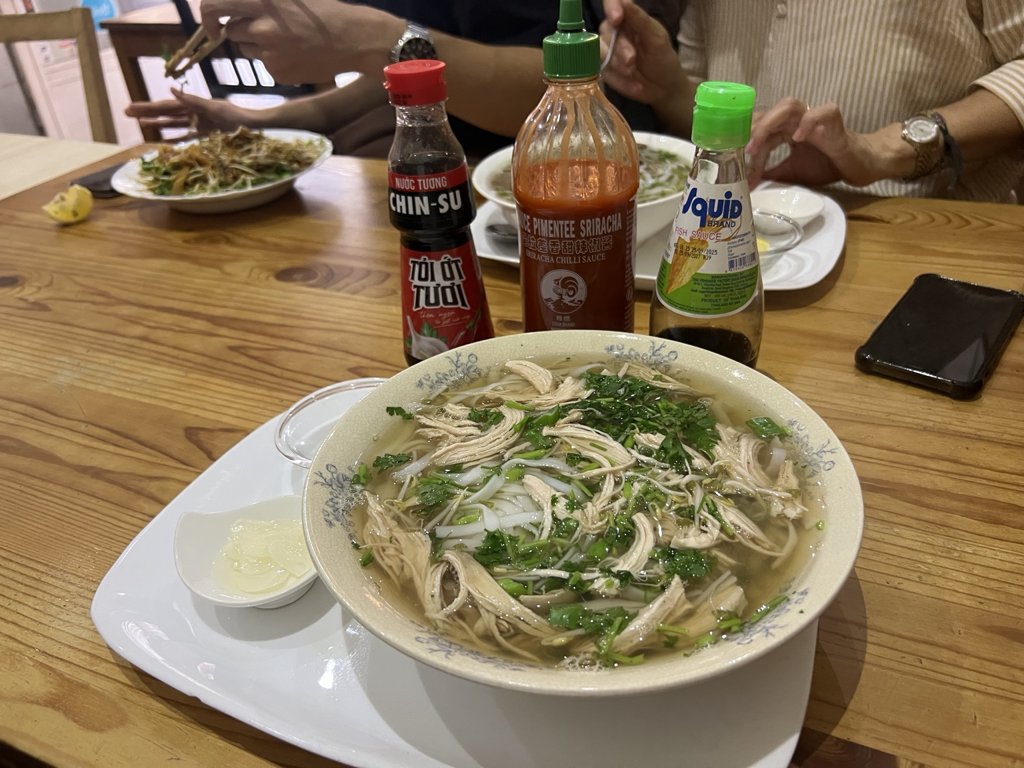 Pho bowls and a noodle plate on our table at Pho Very Good