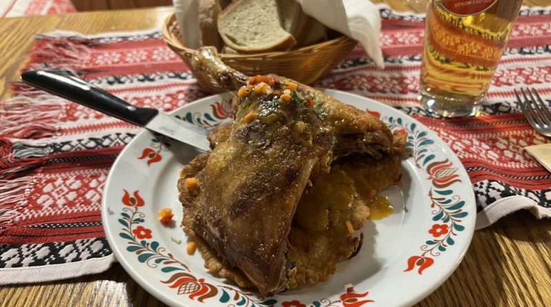 Roast duck served over cabbage and potato tócsni at Pipa Étterem