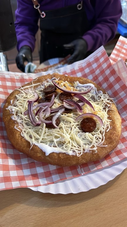 The sausage-and-red-onion version being prepared at the counter