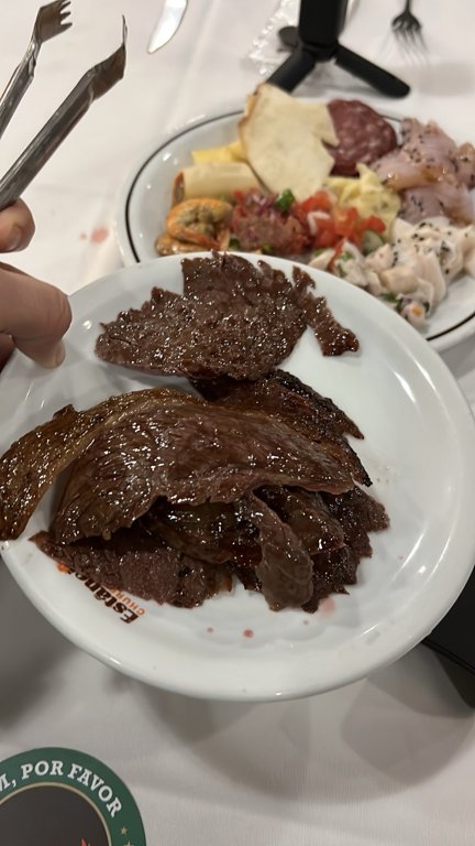Slices of meat served on our plate at Churrascaria Estância