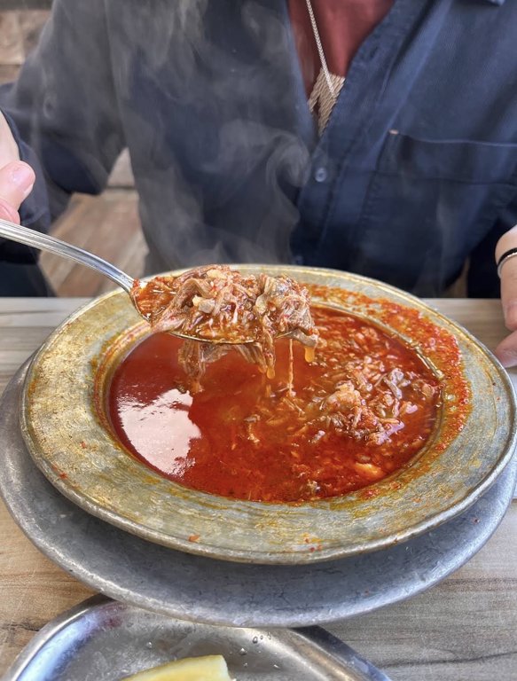Steaming beyran with lamb and rice on a spoon at Sakip Usta in Gaziantep