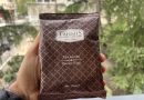 Tahmis Turkish coffee in a 100 g packet held in a hand
