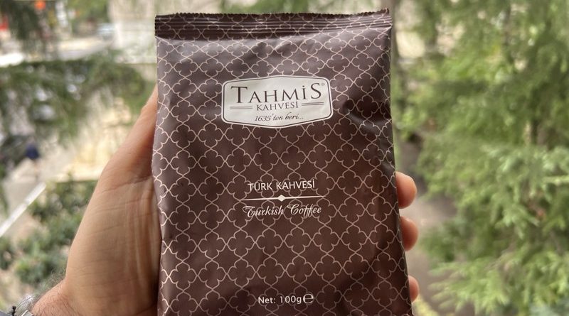 Tahmis Turkish coffee in a 100 g packet held in a hand